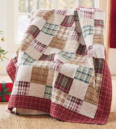 a christmas tree is next to a plaid blanket