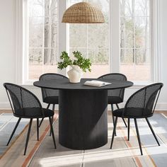 a dining table with four chairs around it