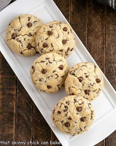 four chocolate chip cookies on a white plate