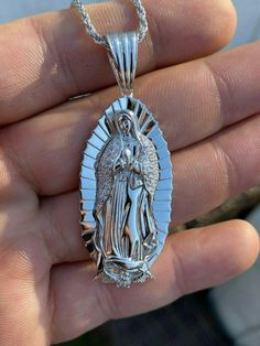 Gorgeous handmade Virgin Mary pendant
Will never turn green! SOLID 925 SILVER...Great investment!
1x2"Pendant weighs 9 grams!VERY DETAILED.Amazing handmade pieceYou can buy pendant alone or with choice of  2.5mm solid 925 silver chain.Chain is Made in Italy & comes in 18-30"If you look to buy only pendant it will fit most chains up to 5mm thick...would look really nice on a tennis chain too! Spiritual Silver Necklace With Our Lady Of Guadalupe, Silver Our Lady Of Guadalupe Pendant Jewelry, Mary Guadalupe, Virgin Mary Pendant, 10k Gold Chain, Red Stone Ring, Tennis Chain, Gold Chain With Pendant, White Gold Chains