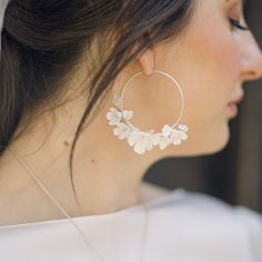 A stunning pair of handcrafted Cherry Blossom floral bridal hoop earrings , with tiny subtle Swarovski crystal stamen centres.  Each flower is intricately handcrafted and wired with delicate crystal.  The perfect feminine, statement wedding earrings to complete your bridal look. Available in 14k gold filled hoops or Sterling silver please select your required finish prior to checking out. These bridal earrings are perfect for city weddings, relaxed boho style weddings and are perfect to wear lon Delicate Flower Charm Hoop Earrings, Delicate Handmade Dangle Jewelry With Flowers, Delicate Handmade Flower Dangle Jewelry, Delicate Handmade Flower Drop Earrings, Delicate Hoop Jewelry With Flower Charm, Delicate Silver Hoop Earrings For Anniversary, Delicate Handmade Flower Jewelry For Wedding, Elegant Hoop Flower Earrings With Flower Charm, Elegant Flower-shaped Hoop Earrings For Wedding