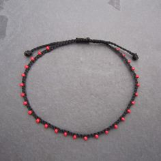 "♡Listing is for one dainty seed bead bracelet or anklet as featured and your choice of card♡ Perfect for everyday wear. Super dainty and minimalist look. Great way to add a little color to any outfit. Makes a very dainty stacking bracelet too. *Featured: Cord color- Black Beads- Red Closure- B. No Beads *Material: Item is made with sturdy nylon cord. The cord resembles silk and color will not fade away. Tiny glass seed beads are carefully hand braided as the highlight of this item. *Card: A pos Dainty Handmade Adjustable Anklets, Handmade Dainty Adjustable Anklets, Handmade Adjustable Dainty Anklets, Gift Anklets With Tiny Beads, Beaded Bracelet Anklet As Gift, Adjustable Beaded Anklet As A Gift, Minimalist Handmade Beaded Anklets, Minimalist Handmade Anklets With Round Beads, Dainty Adjustable Anklets As Gift