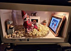 an image of a television set with popcorn on the table and santa clause in the background