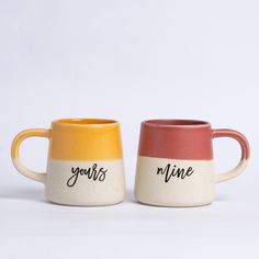 two coffee mugs with the words yours mine written on one side and yours mine painted on the other