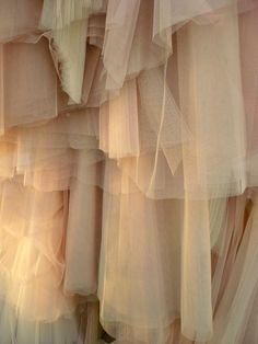 there are many layers of tulle hanging on the wall