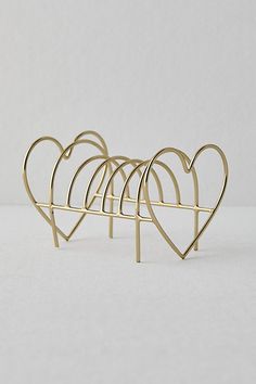 three heart shaped racks on a white surface