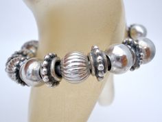 Fine Jewellery - This is a sterling silver cuff bracelet loaded with fluted, plain and antiqued ornate beads and spacers. It has an inside circumference of 5.25", opening is 1.25", slightly flexible, comfortable putting on and off, weight is 30.8 grams, no marks. The bead on one end can be unscrewed and beads can be removed, if desired.