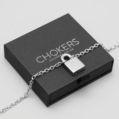 A small to mid sized silver cable chain perfect for a more understated and discreet look when the padlock is worn to the rear. This gorgeous padlock necklace forms part of our 24/7 Day Collar range making it perfect for all day & everyday use, non tarnish and considered hypoallergenic it's the perfect choice. 4mm Solid Stainless Steel Cable Chain Full 316L Stainless Steel Padlock Standard Hex (Allen) Key Supplied Comes in Gift Box as pictured at no extra cost Suitable for 24/7 Wear Hypoallergeni O Ring Choker, Gothic Bracelet, Word Necklace, Gothic Pendant, Padlock Necklace, Day Collar, Bracelet Box, Gothic Earrings, Layered Chokers