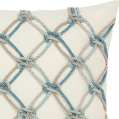 a white pillow with blue and grey rope on it's sides, sitting on a white surface