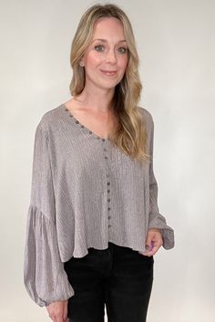 Stunning and sophisticated, you simply cannot go wrong with our Buttons Blouse. With a lined, v-neck design and lavish gray and lavender undertones and a patterned print, this blouse will have you dressed for your day in no time. Its faux button front ensures a secure, yet comfortable fit with no gapping, while buttons and button hooks run along the neckline for an extra touch of style. A truly luxurious essential that looks and feels perfect. Gray V-neck Blouse For Fall, Taupe V-neck Top For Fall, Chic Taupe V-neck Top, Chic Gray V-neck Top, Chic Gray V-neck Blouse, Fall Taupe V-neck Top, Casual Gray V-neck Blouse, Dripping Springs Texas, Nickel And Suede