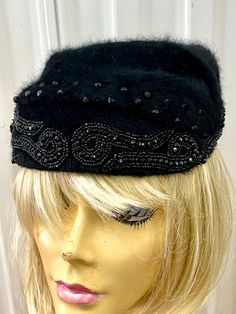 A BLACK SOFT FUR HAT WITH GREAT LOOKING RHINESTONE AND BEAD PATTERN ON THE FRONT - MADE BY VOGUE HATS NEW YORK.I AM NOT SURE OF THE FUR BUT THINK IT IS RABBIT.NO SIZE LABEL BUT SHOULD FIT MOST HEADS. Adjustable Cloche Hat For Evening In Winter, Elegant Black Hat, One Size Fits All, Elegant Black One Size Hat, Black Cloche Hat For Winter Party, Black Brimmed Hat With Rhinestones, Black Winter Cloche Hat For Party, Evening Costume Hats With Short Brim For Winter, Adjustable Mini Hats For Winter Evenings, Black Winter Party Cloche Hat