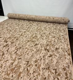 a rolled up carpet on top of a bed