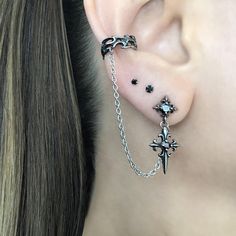 LISTING FOR 1 PIECE ONLY Gothic inspired Cross earring is attached with a chain to the Ear cuff.  Cuff part of the earring needs no piercing, just slide on the ear. This cuff fits both right and left ears.  Material:316 Stainless steel/ set with Black Cubic Zirconia stones Total earring length"  3 1/2"  Cuff :5.5 mm Cross stud:  25 mm *RETURNS / REFUNDS * -If you would like to return you purchase , please contact us within 7 days of receiving your package and we will accept the return.Return will only be made to the product, and not the shipping cost.  -Buyer is  responsible for the return shipping costs . -All jewelry must be returned unworn and in their original condition . *LOST MAIL* Once the package is marked as DELIVERED by the post office, we are not responsible for misplaced or sto Gothic Ear Piercings, Silver And Black Earrings, Goth Earrings Aesthetic, Goth Ear Piercings, Gothic Piercings, Alt Earrings, Mens Earring, New Ear Piercing, Cross Earring