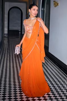 Orange pre-draped saree with glass bead, sequin, cutdana embroidery. Paired with front cut-out embroidered padded blouse. - Aza Fashions Pre Draped Saree Designs, Orange Saree With Black Blouse, Orange Georgette Saree, Beaded Saree Blouse, Indian Wedding Guest Lehenga, Sangeet Outfit Guest, Orange Haldi Outfit, Orange Saree Blouse Combination, Saree Outfit For Wedding