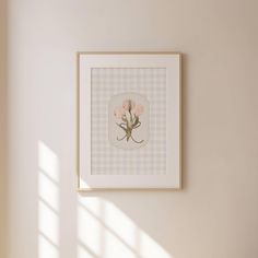 a white wall with a pink flower on it