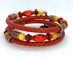 This one of a kind bracelet is made from copper memory wire and 5mm braided leather in orange and adorned with orange Agate beads, rust Howlite, yellow River Shell and antique copper metal spacers beads.  Bracelet is made of memory wire and will fit most wrist sizes.   I invite you to come on in and browse my shop's entire selection of handcrafted jewelry! https://www.etsy.com/shop/BeauFaireCreations Adjustable Copper Bohemian Braided Bracelet, Adjustable Brown Copper Braided Bracelets, Adjustable Copper Braided Bohemian Bracelet, Adjustable Bohemian Copper Braided Bracelet, Adjustable Orange Bohemian Wrap Bracelet, Paper Bead Bracelet, Yellow River, Orange Agate, Memory Wire Bracelet