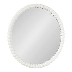 a round mirror with white beads around it