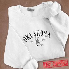 FREE shipping on all additional items Embroidered Oklahoma Sweatshirt "---Production--- - With t-shirts/sweatshirts/hoodies are very suitable for you to coordinate with different styles of clothes. The shirt is soft and warm enough to wear in all seasons of the year. - Please help me double-check the shipping address, and fill out the information you require in the personalization section before purchasing to ensure your order is not delayed. - 50% Cotton, 50% Polyester - Imported - Pull On clos White Embroidered T-shirt For College, White Embroidered T-shirt For Fall, White T-shirt With Embroidered Text For Fall, White Collegiate T-shirt For Winter, White Embroidered Graphics T-shirt For College, White Crew Hoodie With Embroidered Graphics, White T-shirt With Embroidered Graphics For Fall, White Hoodie With Embroidered Graphics, White Hoodie With Embroidered Graphics In Relaxed Fit