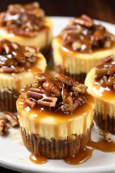 small desserts with pecans and caramel drizzled on them sitting on a white plate