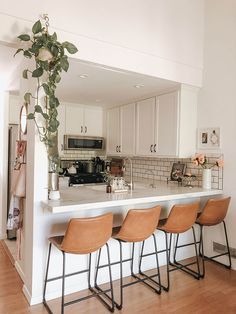 there are four stools at the bar in this kitchen