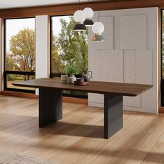 a dining room table in front of large windows