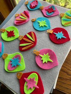 felt ornaments are laid out on a table