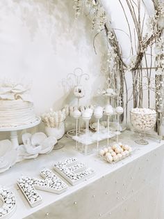 a table topped with lots of white desserts