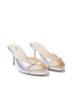 She's subtly sexy, ultra-wearable, and offered in silver-metallic leather. A contemporary backless style, our open-toed Solene mule includes a pointed sole, slim heel and comfortable shaped vamp. With adjustable strap for a customizable fit and jeweled buckle for a touch of glamour. Pairs beautifully with elegant evening looks. Try with polished denim styles for a more elevated look. | L'AGENCE Solene Open Toe Mule In Silver Patent Leather Heeled Mule, Resort Collection, Metallic Colors, Metallic Leather, Shoe Game, Denim Fashion, Shoe Collection, Leather Heels, Mule