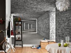 an empty room with brick walls and wooden floors