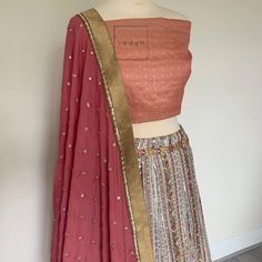 Peach silk fabric with a hint of pink coming through in the blouse/choli fabric. A light two tone affect , Vintage vibe lahenga skirt in antique embroidery in thread work, small matt sequence, aari and jardosi work.  It's absolutely breathtaking in real Dusky pink dupatta with an antique bronze dupatta border The blouse material can be stitched as per your convenience and your style preference at your local tailor. Pink Resham Embroidery Choli In Chanderi, Pink Chanderi Choli With Resham Embroidery, Navratri Brocade Choli With Intricate Embroidery, Pink Anarkali Set With Intricate Embroidery In Art Silk, Diwali Brocade Choli With Intricate Embroidery, Designer Embroidered Brocade Choli, Pink Chanderi Lehenga With Intricate Embroidery, Unstitched Bollywood Brocade Choli, Bollywood Style Embroidered Brocade Lehenga