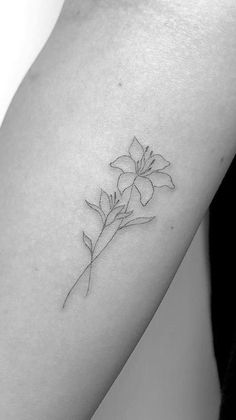 a single flower tattoo on the arm