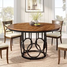 a dining room table with chairs around it and a bowl of fruit on the table