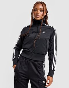 Layer up in a throwback style with this women's Firebird Track Top from adidas Originals. In a Black colourway, this slim-fit track top is made with smooth, lightweight recycled poly fabric for lasting comfort. It features a full-length zipper with a ribbed funnel neckline, and long sleeves with elasticated trims to secure the fit. With two front pockets for quick storage, it's finished with adidas' iconic 3-Stripes down the sleeves and signature Trefoil branding to the chest. Machine washable. | Our model is 5'8" and wears a size medium. | IL8764 Adidas Adicolor, Adidas Classic, Black Knit Top, Adidas Windbreaker, Adidas Original, Polo Sport Ralph Lauren, Adidas Track Jacket, Adidas Originals Women, Zip Hoodies