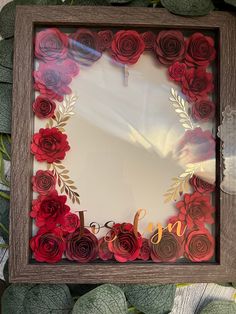 a photo frame made out of paper flowers