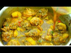 a pot filled with meat and potatoes being stirred by a ladle to make stew