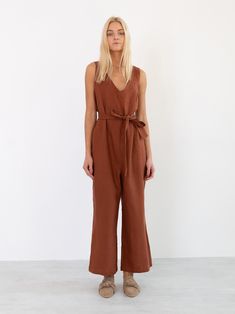 "MADELINE is a sleeveless loose fit linen jumpsuit. DETAILS - V-neckline on front and back - Wide cropped leg - Self tie belt - 100% lightweight European linen fabric - Cut and sewn to order just for you in our studio COLOR - Rust, you can also choose other colors above - Fabric samples are available here https://www.etsy.com/listing/586569696/linen-fabric-samples SIZING & FIT - Relaxed, loose fit - Length is approximately 52 inches / 132 cm - Bust is approximately 18 inches / 46 cm - Measur V-neck Brown Jumpsuits And Rompers For Beach, Spring Linen Jumpsuit With V-neck, Spring Linen V-neck Jumpsuit, Linen V-neck Jumpsuits And Rompers For Spring, Brown Sleeveless Summer Jumpsuit, Sleeveless Brown Jumpsuits For Workwear, Brown Sleeveless Summer Jumpsuits And Rompers, Casual Sleeveless Linen Jumpsuit, Casual Sleeveless Linen Jumpsuits And Rompers