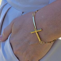 Express faith and elegance with our Stainless Steel Gold Filled Cross Bracelet. This 18K gold filled piece features a cross charm, embodying a dainty and meaningful symbol for Christians. It's a perfect religious gift for her, combining devotion with delicate style. ✨Product Features ✨ * Stainless Steel - 18k Gold Filled  💎 Size 💎 6.5 inc+1 Extender * Antitarnish * Hypoallergenic * Handmade in USA 💎 Material 💎 * Stainless Steel * Our products are produced by hand in our workshops. * Our jewe Adjustable 14k Gold Cross Jewelry, Adjustable Yellow Gold Cross Jewelry, Adjustable Yellow Gold Crucifix Jewelry, Elegant Adjustable Crucifix Jewelry, Adjustable Gold Cross Pendant Jewelry, Gold Cross Bracelets For Gifts, Yellow Gold Cross Bracelets As Gift, Yellow Gold Cross Bracelet Gift, Yellow Gold Cross Bracelet For Gift