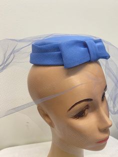 "Blue Fascinator Mid Century Hat With Bow And Veil.  Fits on top of head so it will fit anyone. Made for possibly a bridesmaid. Lightweight.  Attached comb.  1 3/4\" high 6\" across" Party Fitted Fascinator With Satin Bow, Adjustable Fascinator With Matching Headband For Formal Occasions, Formal Adjustable Fascinator With Matching Headband, Formal Fascinator With Satin Bow, Spring Party Fascinator With Satin Bow, Adjustable Bow Hair Accessories For Wedding, Adjustable Wedding Fascinator With Satin Bow, Spring Party Hair Accessories With Satin Bow, Blue Adjustable Headband Costume Hat