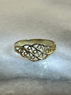 Dainty vintage 14K yellow gold ring. This lovely ring was made using milgrain and filigree style scroll designs. The ring weighs 1.17g and is a size 4.25. Band is stamped 14K with OR maker's mark for OroAmerica Jewelers. Gold was tested via Gemoro AuRacle AGT3. Ornate Engraved Yellow Gold Filigree Ring, Yellow Gold Engraved Filigree Ring, Yellow Gold Engraved Filigree Promise Ring, Yellow Gold Engraved Ring With Filigree, Yellow Gold Engraved Ring With Intricate Design For Anniversary, Victorian Yellow Gold Engraved Ring With Intricate Design, Engraved Yellow Gold Filigree Promise Ring, Victorian Style Engraved Yellow Gold Ring With Intricate Design, Victorian-style Yellow Gold Engraved Ring With Intricate Design