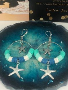 These darling sea star hoop earrings are made with turquoise, white and blue, 6 mm clay spacer disc beads, silver sea star dangles & sterling silver French earring hooks.  They are so stunningly gorgeous, and they are the perfect beach accessories. Blue Hoop Earrings With Ear Wire For Beach, Handmade Hoop Earrings For The Beach, Handmade Turquoise Jewelry For Beach Party, Blue Small Hoop Jewelry For Beach, Blue Small Hoop Jewelry For The Beach, Handmade Star-shaped Jewelry For Vacation, Handmade Star Shaped Jewelry For Vacation, Ocean-inspired Dangle Hoop Earrings For Beach, Handmade Turquoise Hoop Earrings For Beach