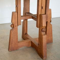 a small wooden table with two chairs on it's legs and one chair in the middle