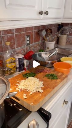 a wooden cutting board sitting on top of a kitchen counter