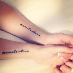 two people are holding hands with tattoos on their arms that say, love and laughter