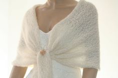 a mannequin wearing a white knitted shawl