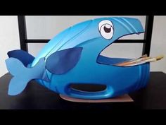 a blue plastic toy fish sitting on top of a table