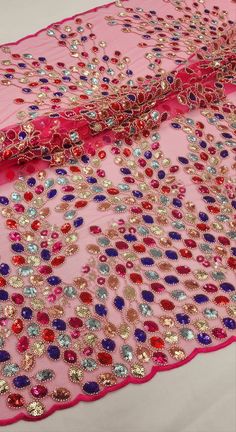 a pink and red scarf with sequins on it