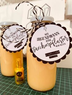 two jars filled with liquid sitting on top of a table