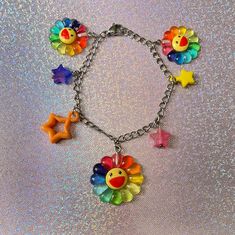 If everything rainbow is your aesthetic, then this colorful rainbow flower charm bracelet is the perfect match! Every charm bracelet has different colored stars but remains colorful anyways🌈✨. Check out our charm bracelets section for more OOAK items! *Stainless steel chain *Adjustable, reaches up to 6 inches (extra length available below) If you have any questions, please don't hesitate to ask! We are friendly:) Visit our official website: www.theyeetboutique.com and follow us on Instagram: @t Cheap Rainbow Flower Shaped Jewelry, Whimsical Multicolor Jewelry With Dangling Charms, Whimsical Multicolor Jewelry With Charms, Whimsical Multicolor Charms Jewelry, Trendy Multicolor Flower Jewelry, Playful Star Charm Jewelry For Gifts, Fun Multicolor Charm Jewelry, Playful Jewelry With Star Charm For Gift, Rainbow Flower-shaped Jewelry For Gifts