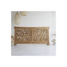 a wooden headboard with intricate carvings on it