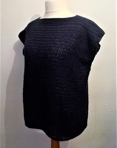 a mannequin wearing a black top with crochet on it